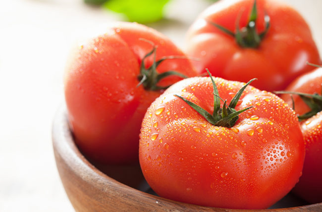 Fresh Tomatoes On Cutting Board