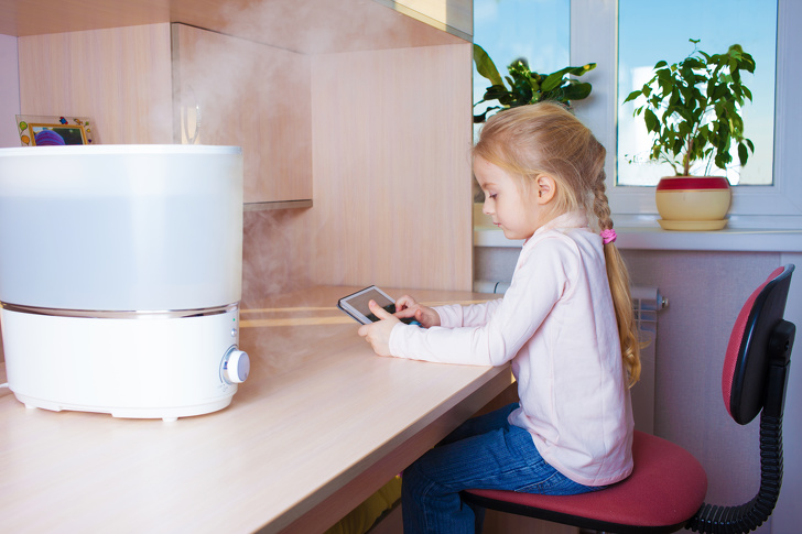 Little Girl With Tablet Pc Sitting Near Humidifier