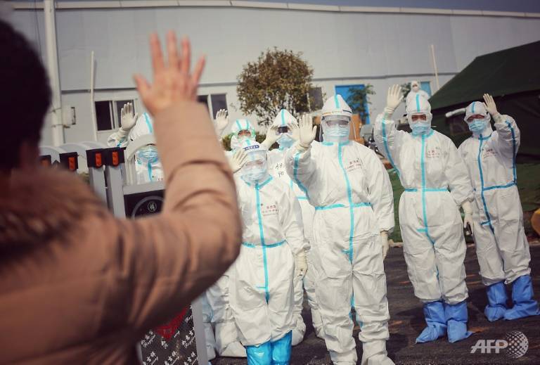 Medical Staff Members Wave To A Recovered Patient At A Makeshift Hospital For The Covid 19 Coronavirus Patients In Wuhan 1583724044764 10